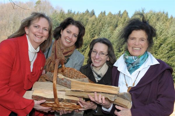 Group photo of four forestry women holding wood in their hands