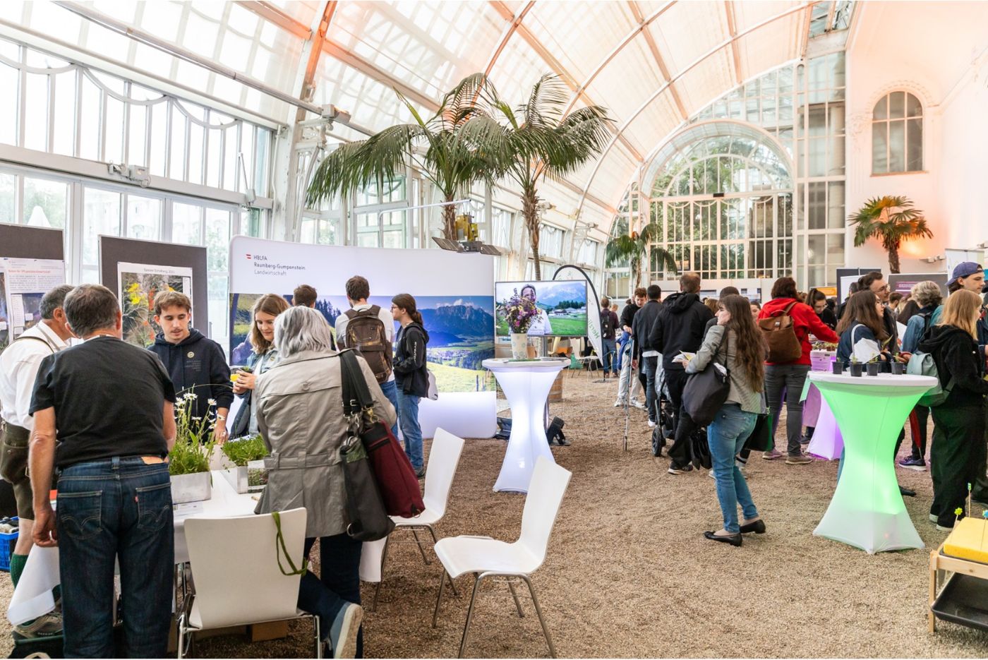 Blick ins Palmenhaus während der Veranstaltung 2024 mit Ständen und Besucherinnen